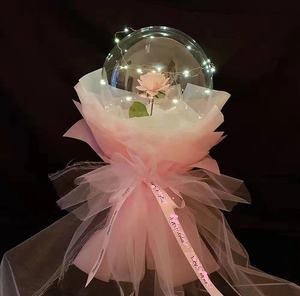Transparent Balloon with 1 pink rose inside and wrapped in white and pink wrapping and led fairy light string