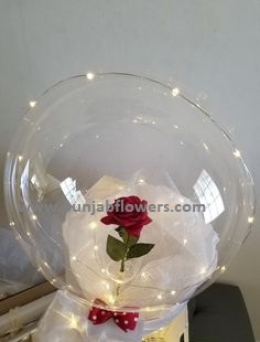 Red rose in a transparent balloon with luminous LED lights